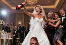 During my older sister’s wedding, my naive 6-year-old daughter unwittingly sat down on the seat. My sister spun around sharply, her voice sharp and cold from anger: “Why do you dare sit here? You will have to pay the price!” Before everyone could react in time, she snatched a wine bottle and struck it against my young daughter’s head with full force. My daughter cried out, blood and wine pouring down its face. I rushed over, but my sister countered again—until it slipped, falling to the floor, its skirt drenched in red wine. When I tried to reach my child, my mother restrained me, snarling that my daughter “deserved to be taught respect,” while my father hurried to soothe my sister. Then the doors flung open—my husband entered, beheld his daughter’s face, and what he did next left the whole venue in silence.