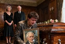 At the post-funeral family meeting, my stepmother gave me a sugary smile as she handed me a cracked photo frame. “This is all he left you. Broken — just like your future.” My half-brother let out a mocking laugh. “Take it and leave, parasite. Everything is mine.” I held the frame quietly, my thumb tracing my father’s faded smile. But when the lawyer slid out an envelope hidden behind the frame’s backing, the whole room went dead silent — and not a single person could muster a smile after that.