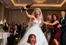 At my sister’s wedding, my innocent 6-year-old daughter accidentally sat in the chair. My sister whipped around, her voice ice-cold with rage: “How dare you sit here? You’ll pay for this!” Before anyone could react, she grabbed a bottle of wine and smashed it into my little girl’s head with all her strength. My daughter screamed, blood and wine streaming down her face. I lunged forward, but my sister fought back—until she slipped, falling to the floor, her dress soaked in red wine. As I reached for my child, my mother held me back, hissing that my daughter “deserved to learn respect,” while my father rushed to comfort my sister. Then the doors burst open—my husband stepped in, saw his daughter’s face, and what he did next silenced the entire hall.