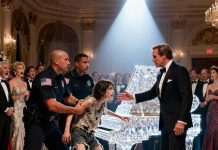 In the middle of the glittering gala, two security guards pulled a frail, homeless girl toward the exit. She twisted in their grip, staring desperately at the shining piano. “Please! Just one song… I’ll trade it for a meal!” The guests snickered. Then the renowned pianist, Lawrence Carter, stepped out of the crowd, rested a hand on her shoulder, and said calmly, “Let her play.” Laughter rippled through the room—until moments later, when she touched the keys… and the entire hall fell utterly silent.