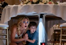 I was sitting quietly with my five-year-old son at the wedding banquet of my sister. Suddenly, he grabbed my hand and whispered, “Mom… let’s go home. Right now.” I asked, “What’s wrong, sweetheart?” He began to tremble and said, “Mom… you haven’t looked under the table… have you?” I slowly bent down to look— and froze. I gripped his hand tightly… and quietly stood up.