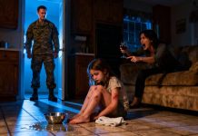 The little girl collapsed to her knees, her tiny hands flushed red and stinging with pain while her stepmother towered over her, shouting, “Clean it up! If you don’t clean, you don’t get dinner!” Exhausted, the child fell forward onto the floor, breathing in ragged gasps as if all her strength had drained away. Suddenly the front door opened and her father—a soldier—returned home earlier than expected. He froze at the sight, then roared, “My daughter… who did this to her?!” The stepmother’s face turned pale, and the little girl whispered, “Daddy… it hurts…” as the fury inside her father began to rise uncontrollably.