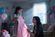 For my daughter’s 8th birthday, my parents sent her a pink dress as a gift. She smiled at first, then suddenly froze and asked, “What is this, Mommy?” When I looked closer, my hands began to shake. I didn’t cry—I acted. The next morning, my parents wouldn’t stop calling.