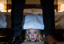 On our wedding night, I hid under the bed, holding back laughter as I waited to surprise my husband. The door opened—but not to him. Instead, a phone was set down on the floor with the speaker on. “Is she inside the room?” a man asked. Another voice answered, “Relax. She won’t suspect anything.” I clenched my teeth to stop myself from screaming, because right then, I understood I had just heard a secret capable of ruining my life completely.