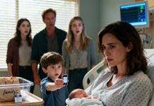 Minutes after I gave birth, they surrounded my bed like a jury. “That child isn’t his,” my father muttered. “No resemblance.” My sister laughed. “Go get a DNA test—seriously, lol.” I was still shaking when my five-year-old climbed closer and said, “Wait… look!” He pulled something out and held it up. My mother’s smile collapsed. My sister went pale. And suddenly, no one dared to speak.