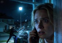 “Promise me you won’t look outside,” my neighbor Clara said over the phone at 2 AM, almost pleading. “If you care about your safety, just stay in bed.” My heart started racing. Who says something like that unless it’s serious? I crept toward the window anyway. The second I peeked through the blinds, my stomach dropped. A figure was standing perfectly still in my yard—staring straight up at my house. And then my porch light flicked on by itself.