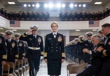 “She dropped out of the Navy,” my father announced to the crowd. I stood quietly at my brother’s SEAL pinning ceremony… invisible, just another shadow in the room. Then a general stepped in front of me and saluted sharply. “Rear Admiral… I didn’t realize you would be attending, ma’am.” Two hundred SEALs stood in unison. The auditorium froze. And for the first time ever… my father’s face lost all color.