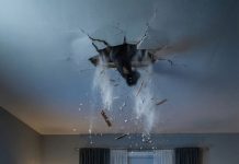 “Turn the music down. Now.” My husband’s voice wasn’t normal—it was tight, urgent. I lowered it slowly… and that’s when we heard it. Heavy footsteps above us. “That’s not possible,” I whispered. We were alone. My husband grabbed my arm. “Don’t look upstairs.” Too late. Something dragged across the floor… then stopped. Right above us.