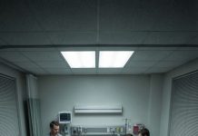 The doctor closed the chart and said quietly, “Your mother can’t live alone anymore.” The room went still. Eight sons and daughters stood around the hospital bed, yet no one stepped forward. Instead, they looked down at the floor like people avoiding eye contact at a bus stop. I lay there watching them, realizing something painful: raising eight children didn’t guarantee one of them would take you home.