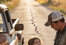 I was seconds away from walking outside and telling the rusted pickup truck to get off my driveway. It had been sitting there all morning, engine idling, looking suspicious. But before I could say anything, the passenger door opened and a tiny eight-year-old girl stepped out. She walked up to me holding a crumpled note that simply said, “My dad heard you help people.” Suddenly that truck didn’t look like trouble anymore.