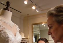 The customer was staring at the $1,200 vintage wedding dress like it was the one—perfect lace, flawless satin, not a mark on it. Then I took a blue ink pen and dragged it across the fabric. She gasped. The whole shop went silent. But I had seen the panic in her eyes when she mentioned the price, and sometimes ruining perfection is the only way to make something affordable.