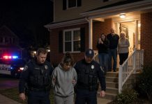 At 1:47 a.m., two officers broke through my front door with a warrant. “You’re under arrest for inheritance fraud,” they announced as my parents smiled behind them and my sister livestreamed everything to more than a million viewers. I didn’t fight or beg. I simply went with them. But at the station, an officer opened my file, suddenly went pale, and stood at attention. Minutes later, the police chief rushed into the room and saluted. “Commander… we had no idea.” I looked through the glass at my family and finally smiled. “Now arrest the people who framed me.” Their livestream was still running when the handcuffs came out.